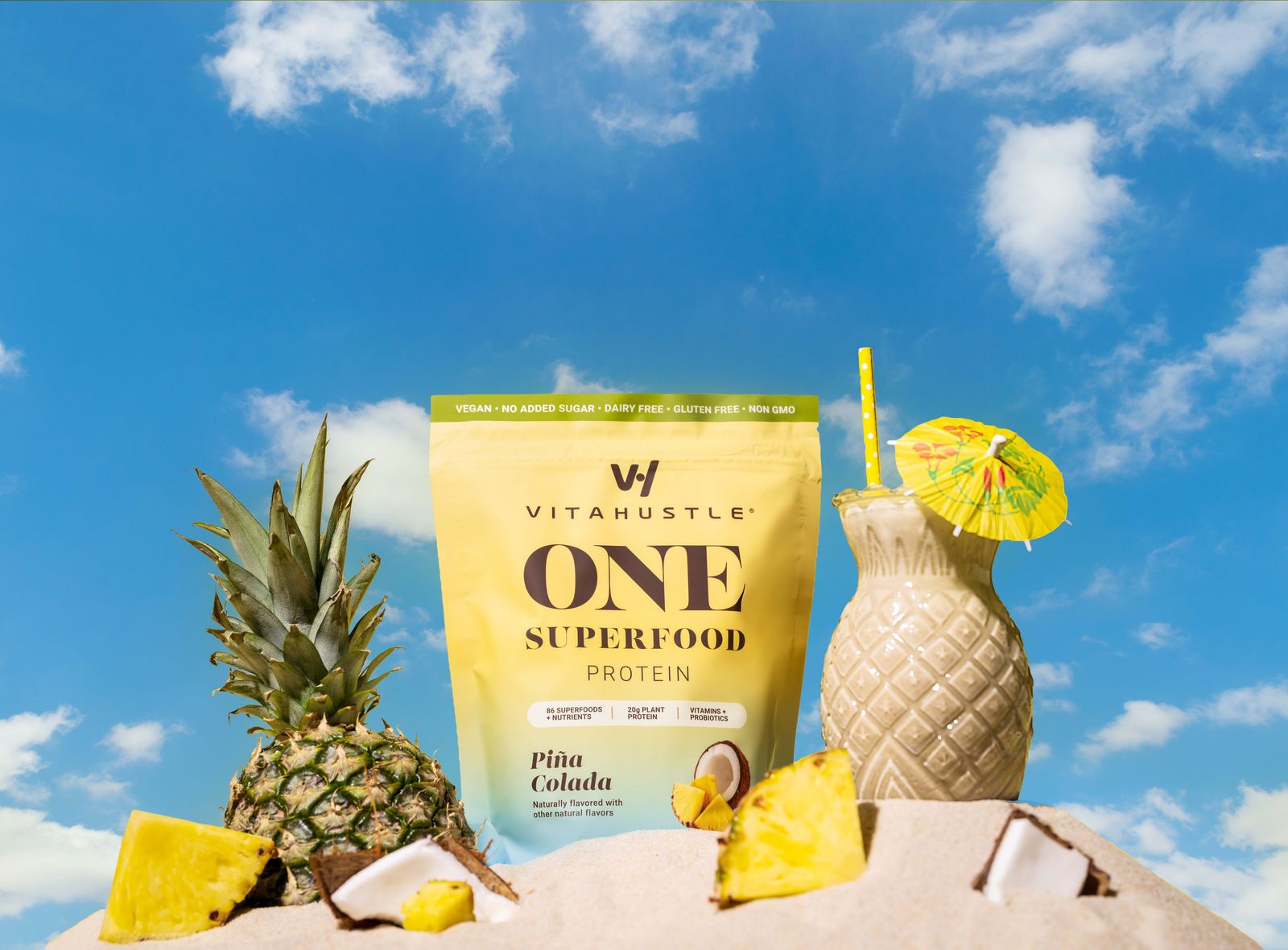 VitaHustle ONE Piña Colada pouch on the beach